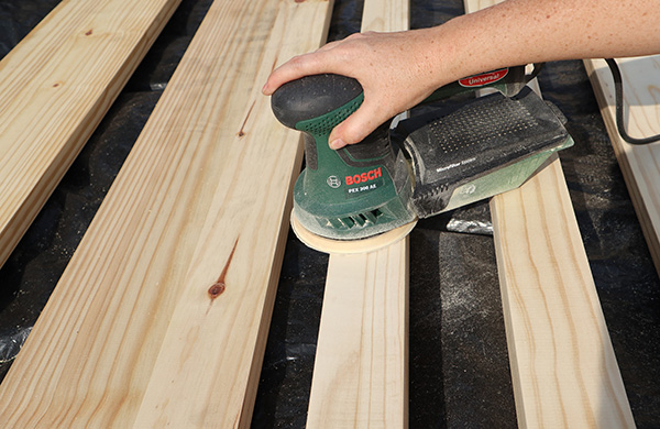 Sand down all the wood surfaces down with an orbital sander.